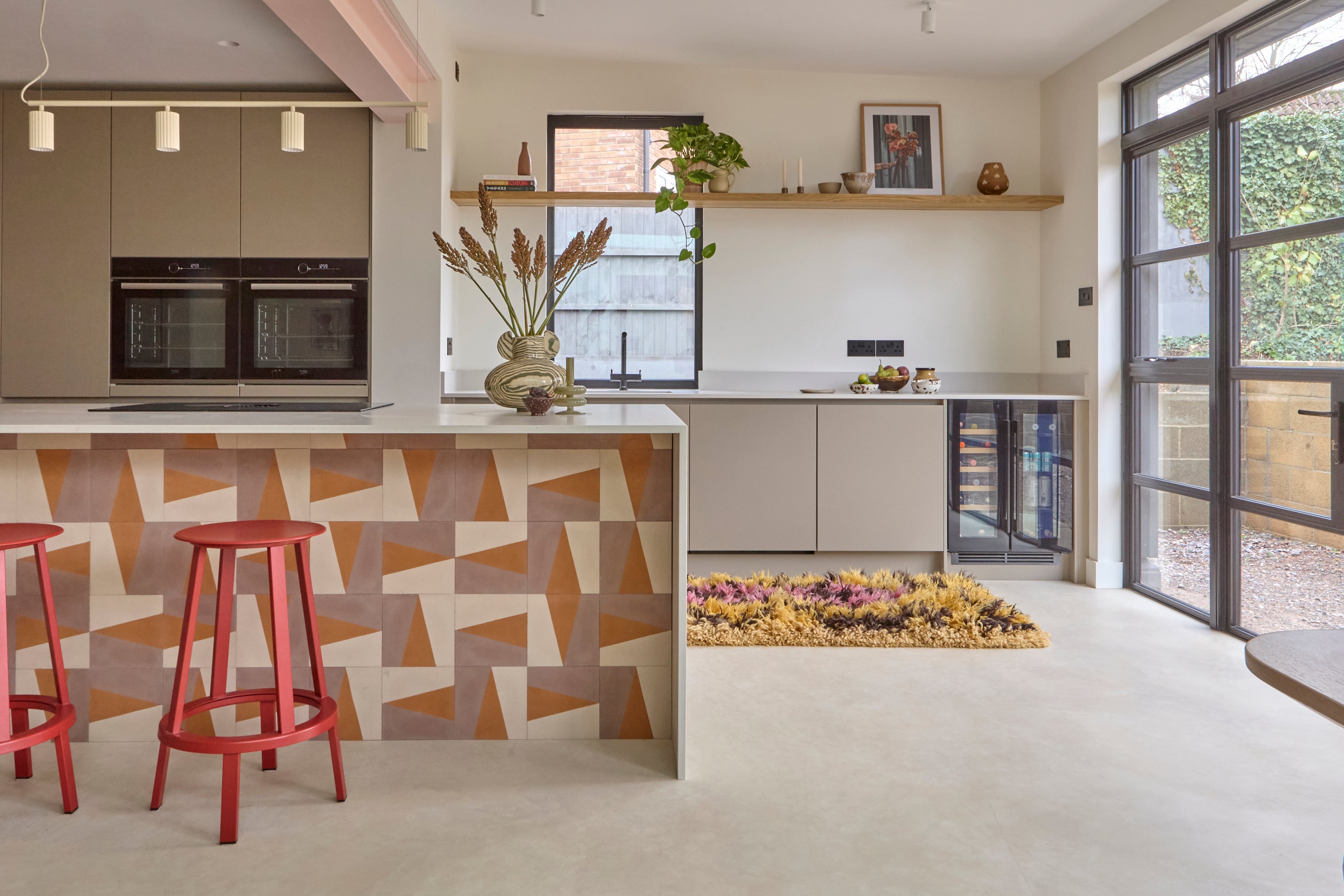 Island encaustic tiles by Bert & May. Quartz kitchen top. Donna pendant lighting. Hay revolver stools. HK living runner rug. Scandi photography artwork