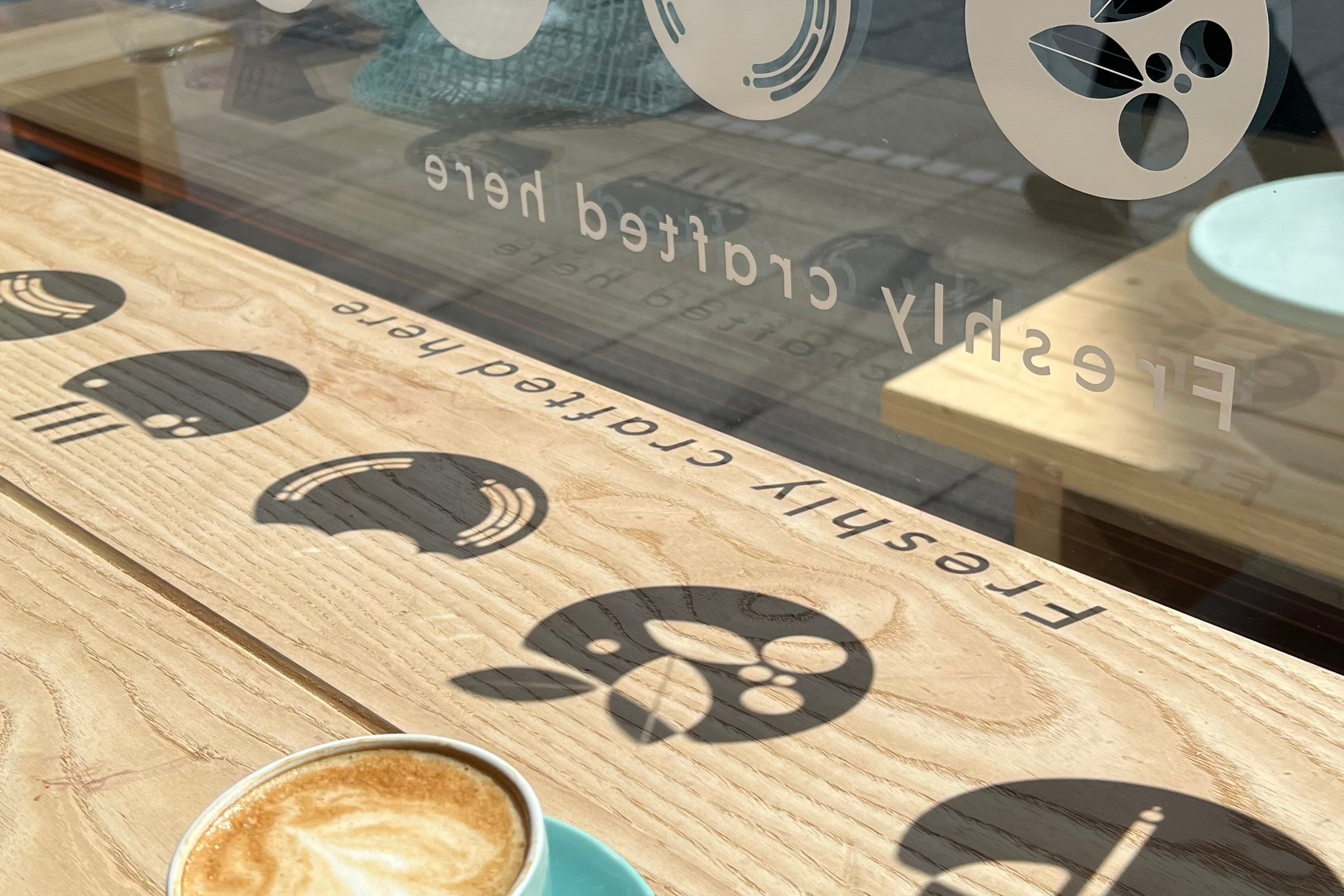 Juice Bros, Bury St Edmunds. Window decal shadow onto table