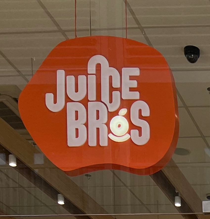 Juice Bros, lit-up orange shop signage