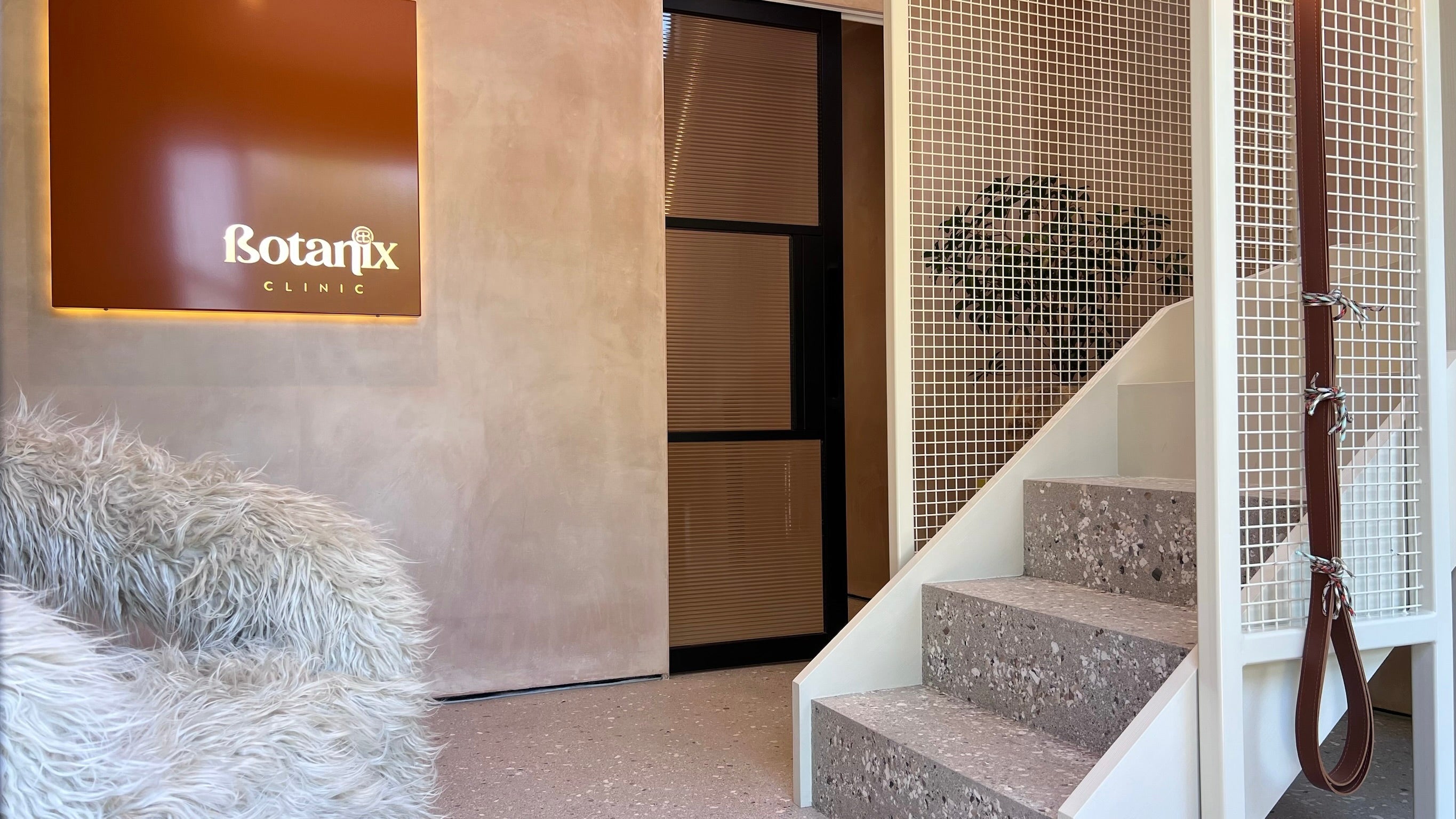 Botanix Clinic, raw plaster walls, microcement floor and stairs, pocket door, powder coated contemporary staircase